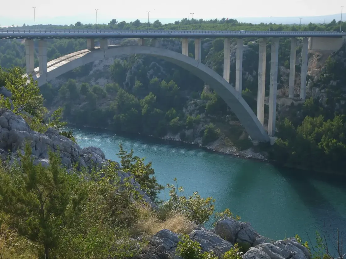 Bridge over the green Krka river at Skradin on the Krka waterfalls and Trogir combo tour from Split